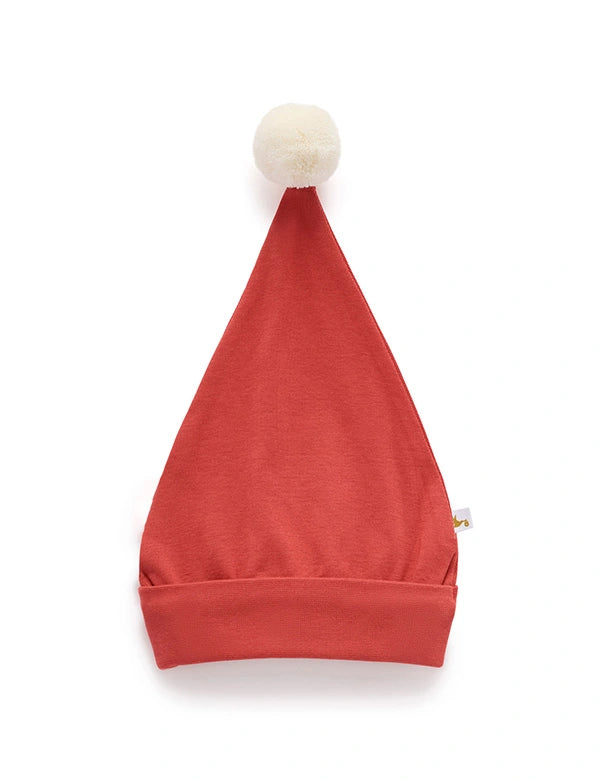 Red baby hat with a white pom-pom on a white background