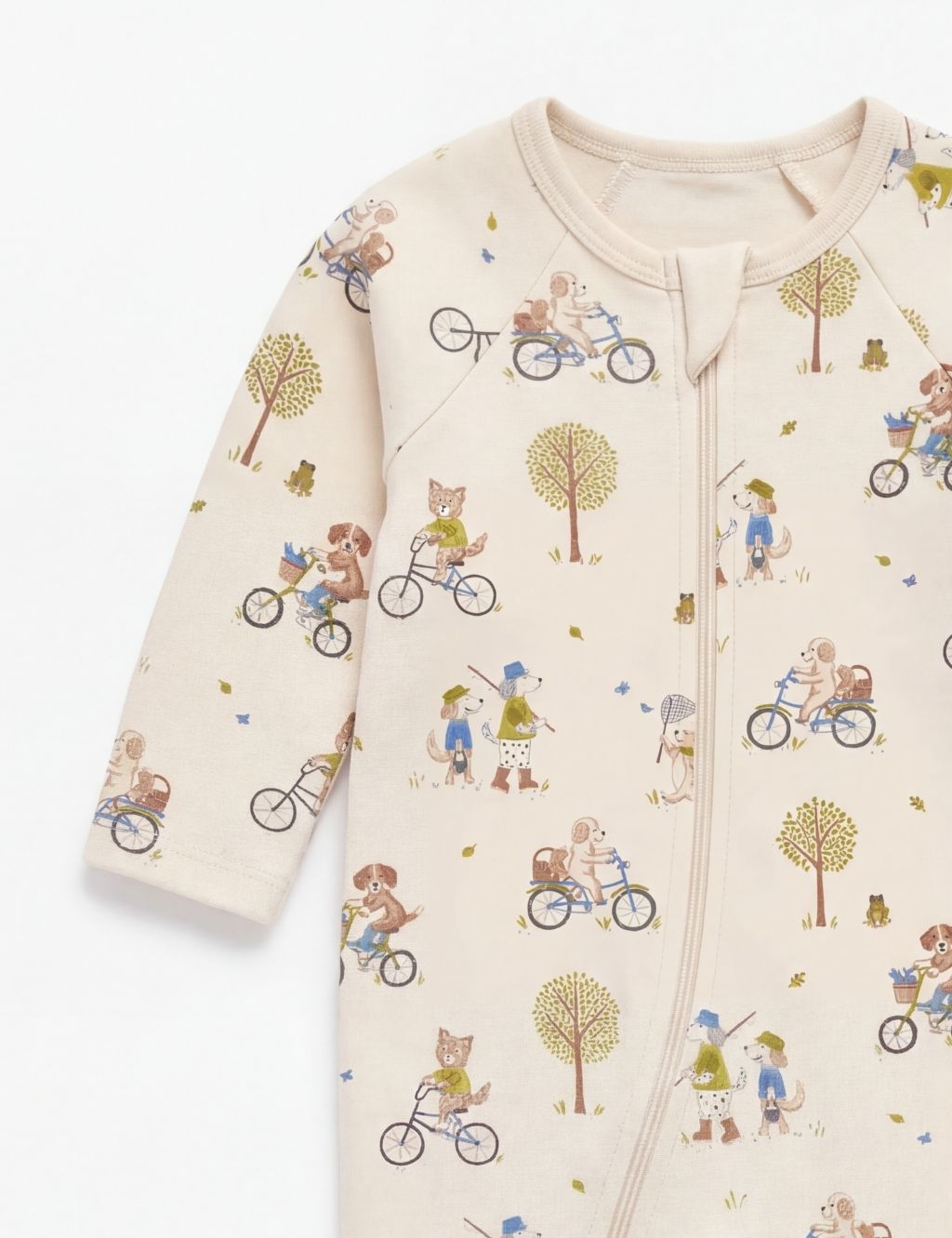 Sleeve detail of a cream organic cotton baby romper showcasing the down river animal pattern.
