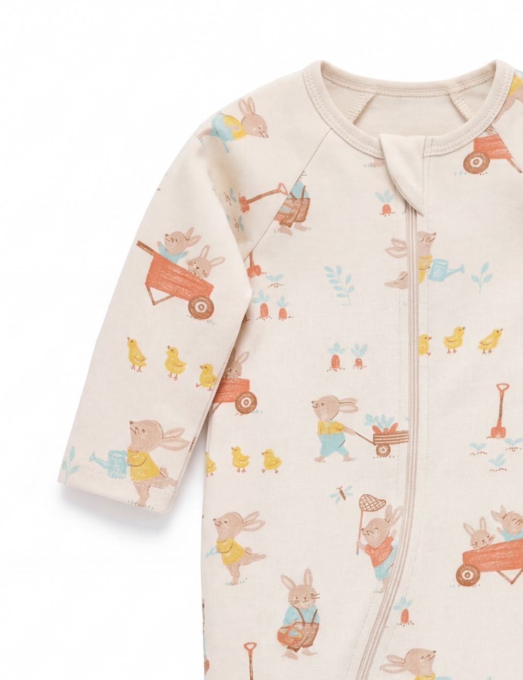 Sleeve detail of a beige organic cotton baby romper featuring cute Easter bunny graphics.