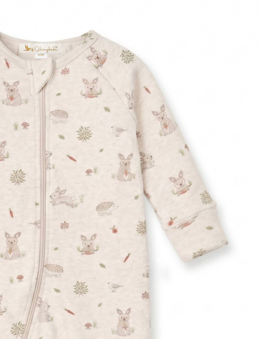Close-up sleeve and shoulder detail of an organic cotton footie romper showcasing the woodland bunny and hedgehog print.