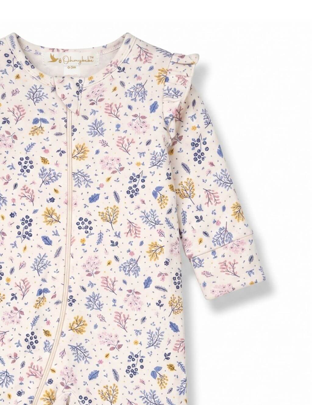 Close-up sleeve and shoulder detail of an organic cotton floral print romper showing the ruffle accent and botanical pattern.