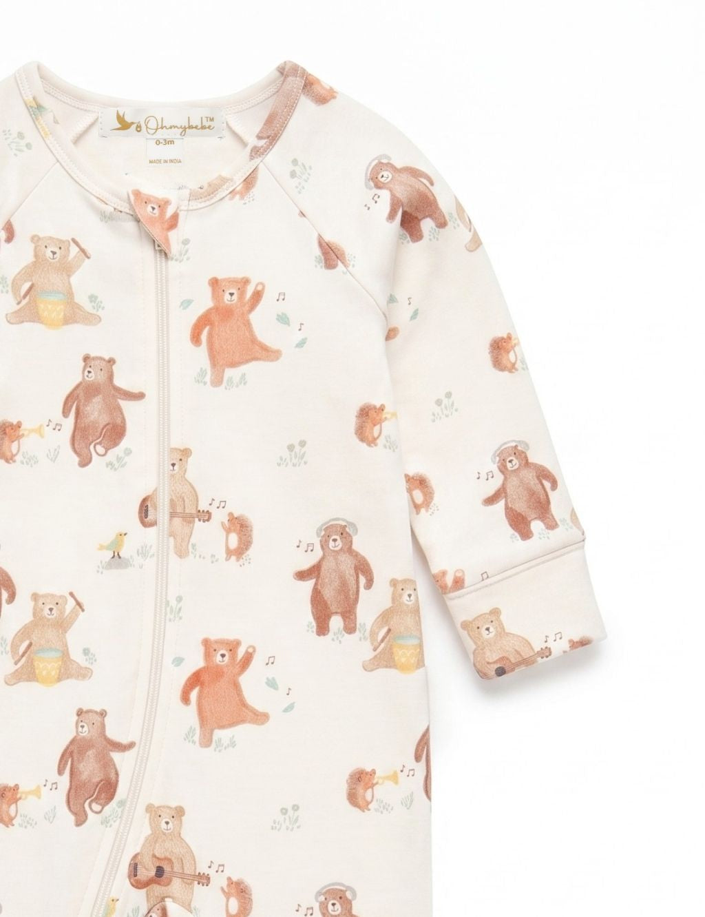 Close-up sleeve and shoulder detail of an organic cotton footie romper showcasing the musical bear print
