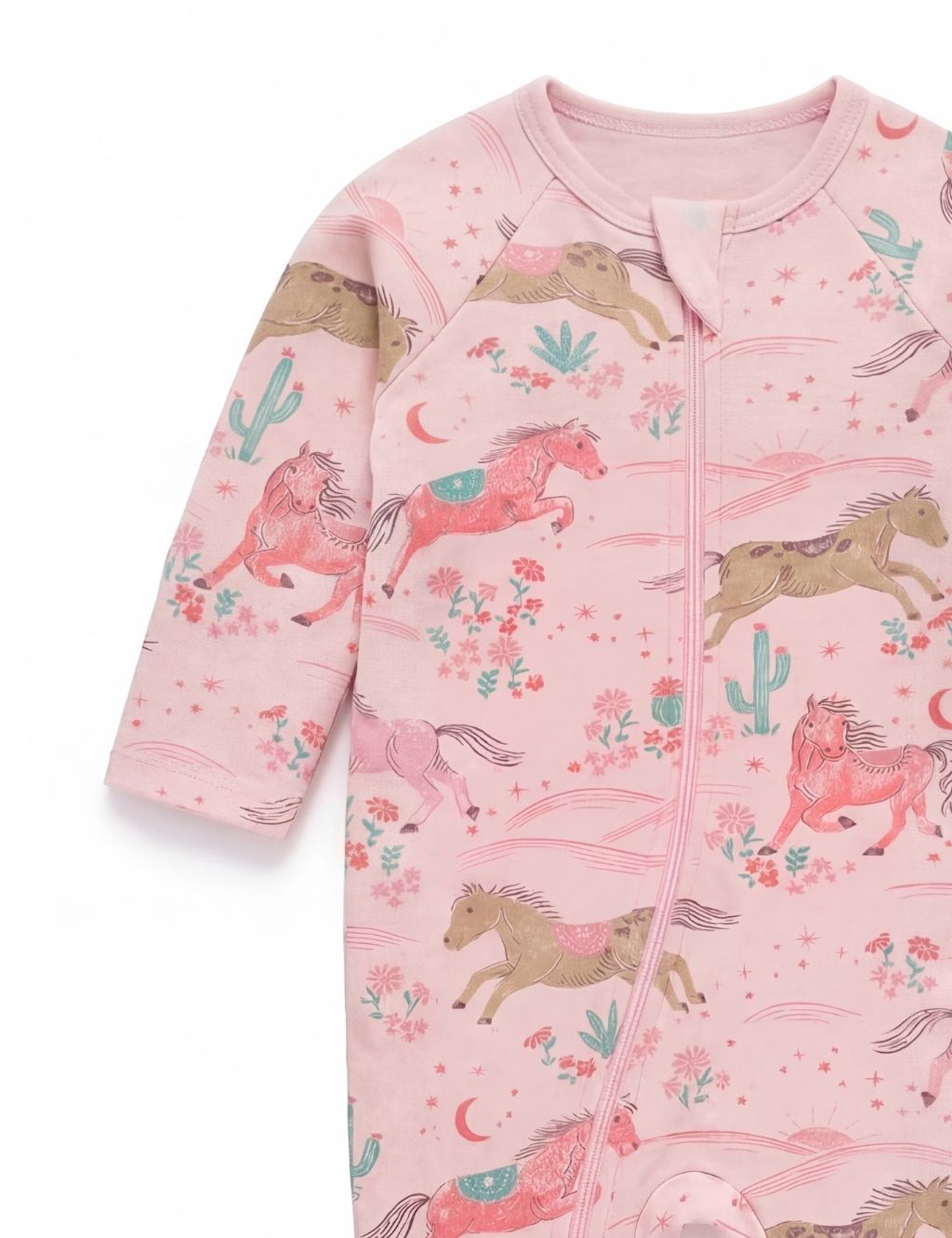 Sleeve and chest detail of a pink organic cotton baby romper with horse prints.