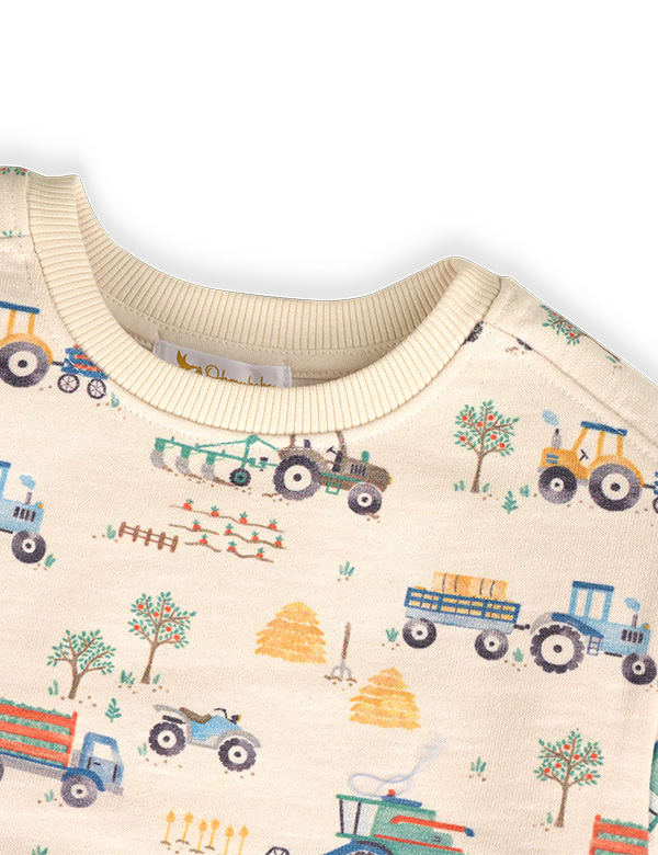 Cream sweatshirt with colorful farm tractor and tree print, featuring haystacks and farming scenes