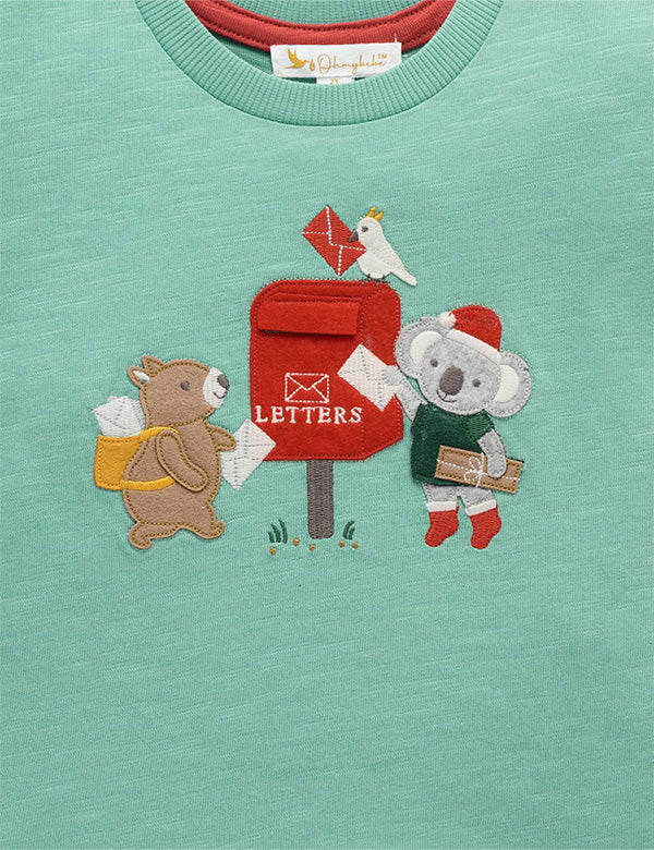 Teal shirt with embroidered design of a bear and koala near a mailbox.