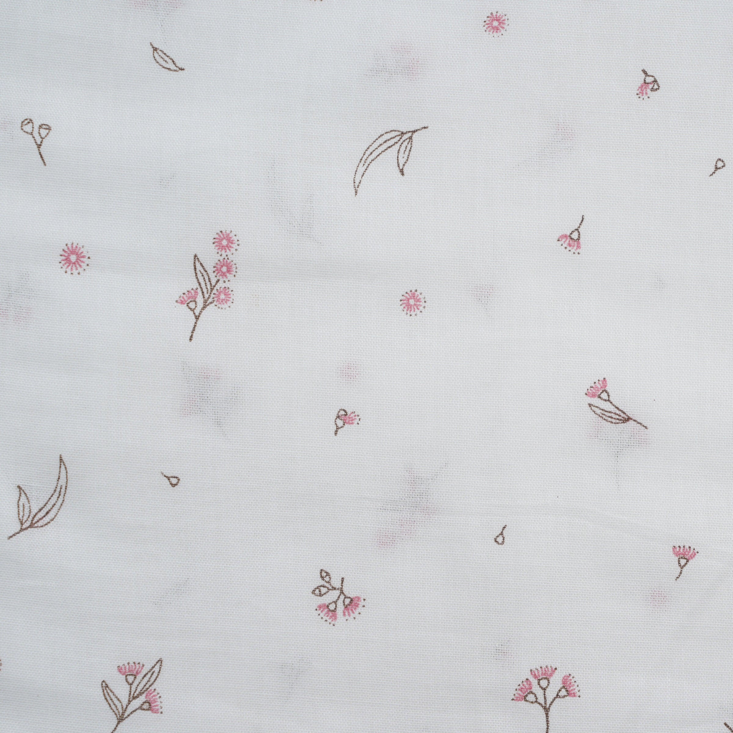 White baby cap with delicate pink and brown floral pattern printed on lightweight fabric