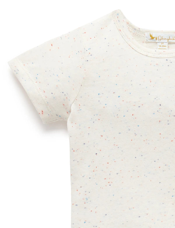 Close-up of a white baby t-shirt with multicolor speckles, short sleeves, and round neckline