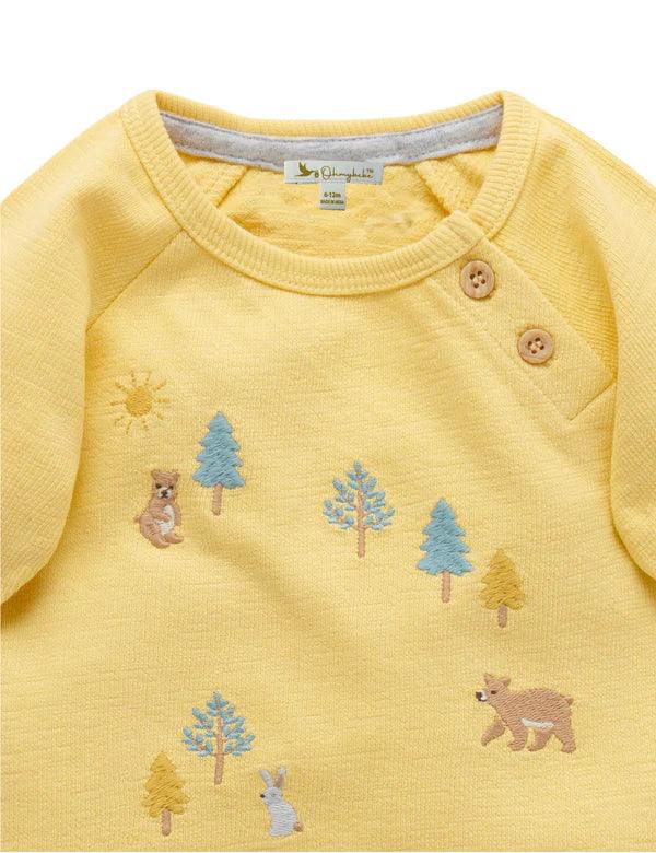 Yellow baby sweatshirt with embroidered forest animals and trees, featuring wooden buttons on shoulder